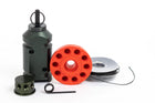 Contents of the 12 gauge and 209 adapter kit, 4 objects: 6061 aluminum perimeter trip alarm standing on end, OD color. A cylinder device, which is the 209 adapter, has holes on the sides. A red circular silicone caddy, donut shape, has 10 holes for primers, it is empty. A spool of Dyneema trip line in the back with a little string out of it. - Thumbnail Image