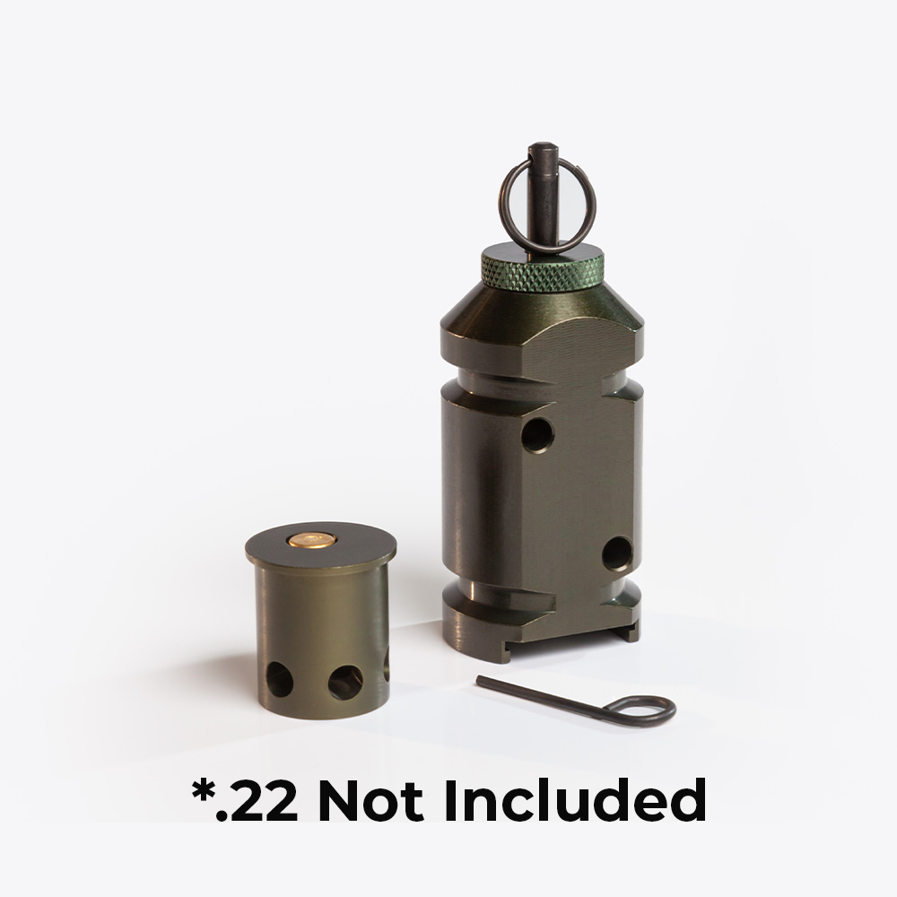 1 trip alarm: two round sides with 2 straight sides, zip tie grooves, and pull pin at the top. Next to an adapter that holds .22 powder loads; a cylinder device with holes at the bottom (flashports)